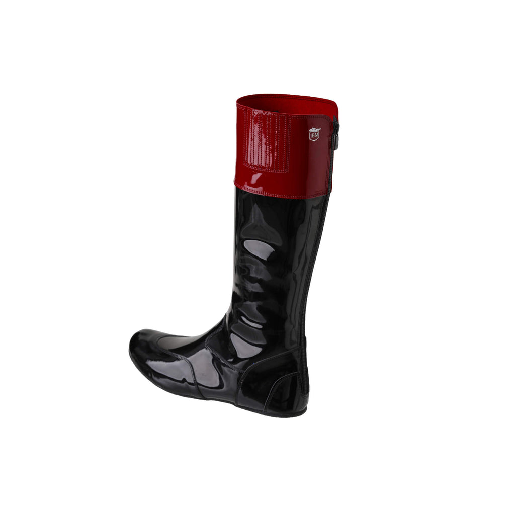 A tall racing boot displayed against a white background. The boot is made of black material with a dark red patent leather accent around the calf area. It features a back zip and a 1.5-2cm stretch feature around the calf. This image only showcases one boot from a side-back perspective.