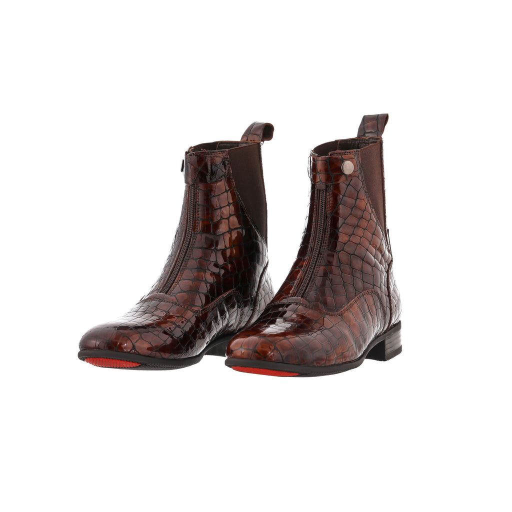 A pair of brown crocodile boots displayed against a white background. Both boots are positioned sole-down, featuring front zip and buckle closures. The angle of the display is slightly positioned to one side, adding a dynamic perspective.