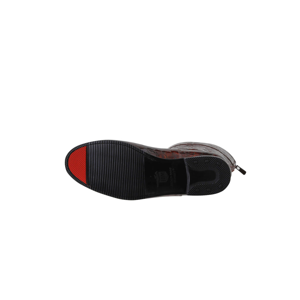 A pair of brown crocodile tall boots featuring a back zip and a 1.5 - 2cm ability to loosen the calf area if required, displayed against a white background. The image shows one boot laid down to showcase the sole, which features a red tip design.