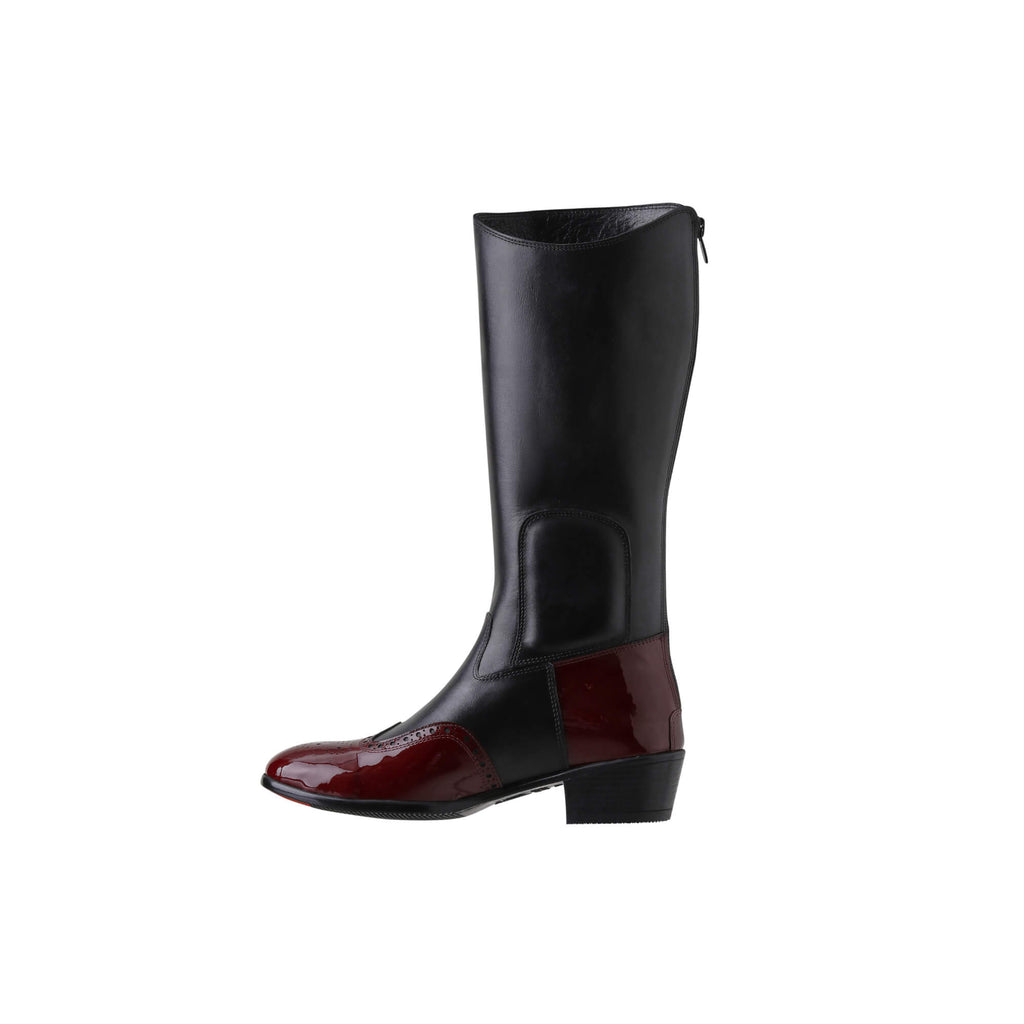 A tall black leather Cuban heel boot with burgundy wingtip accents. The boot features a back zip and is displayed against a white background. This image only showcases one boot from a side perspective.