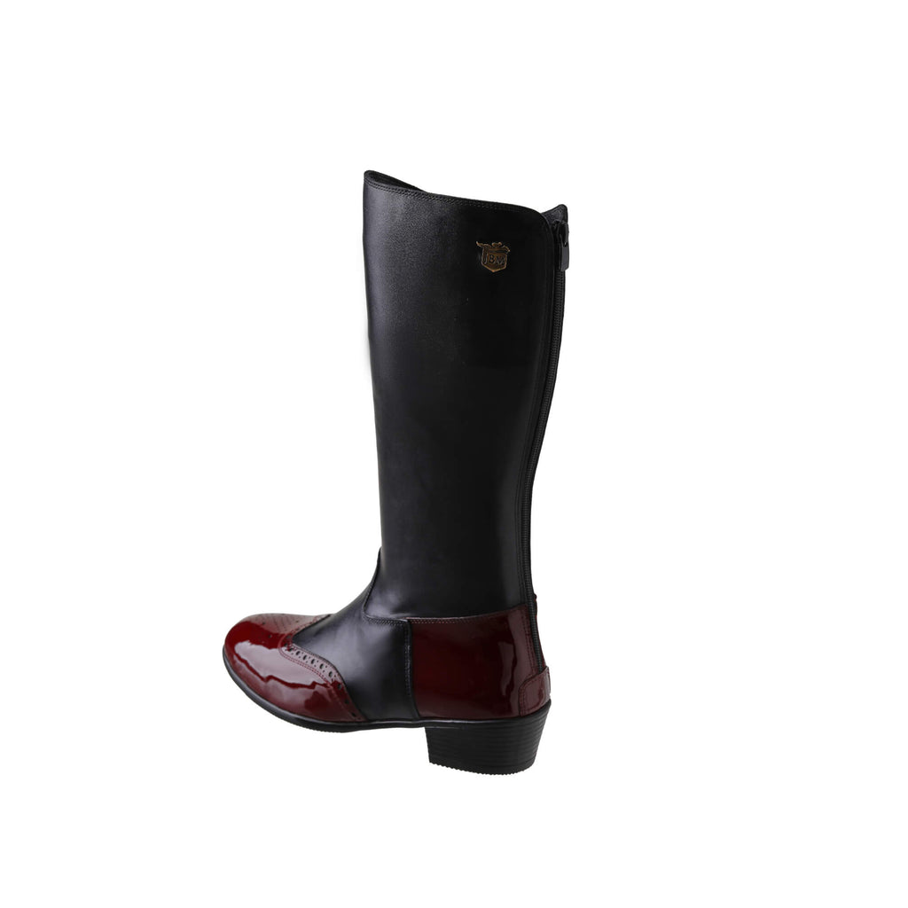 A tall black leather Cuban heel boot with burgundy wingtip accents. The boot features a back zip and is displayed against a white background. This image only showcases one boot from a side-back perspective.